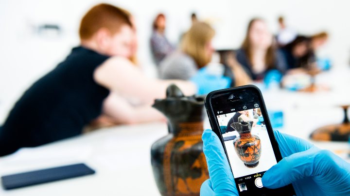 Student using a mobile phone in a lab