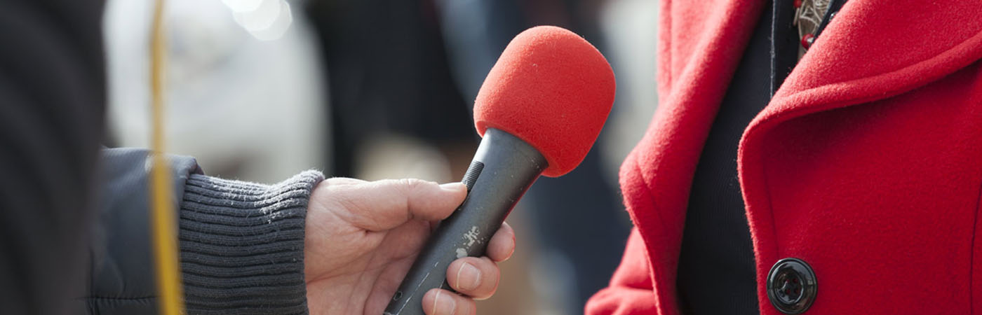 An interviewer holding a microphone