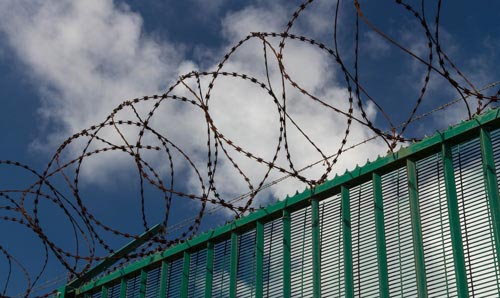 Fence with barbed wire