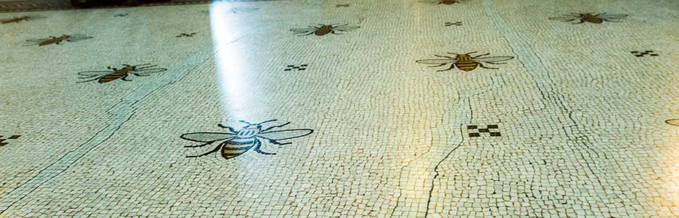 A tiled floor with pictures of bees